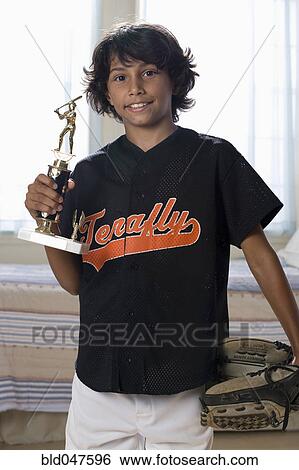 Mixed Race boy holding sports trophy View Large Photo Image Stock Photograph - Mixed Race boy holding sports trophy. Fotosearch