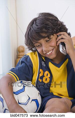 Mixed Race boy talking on cell phone View Large Photo Image Stock Image - Mixed Race boy talking on cell phone. Fotosearch