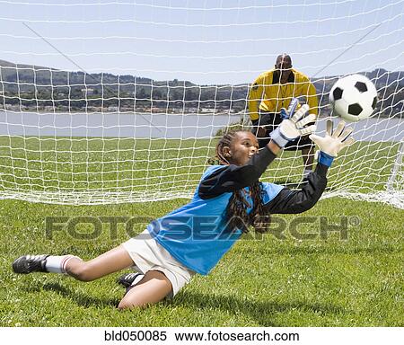 Mixed Race girl playing soccer View Large Photo Image Stock Photography - Mixed Race girl playing soccer. Fotosearch
