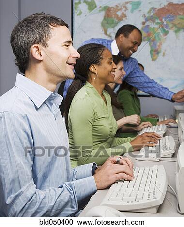 Multi-ethnic businesspeople typing on computers View Large Photo Image Stock Image - Multi-ethnic businesspeople typing on computers. Fotosearch