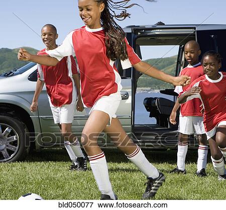 Stock Photo - Multi-ethnic children in soccer uniforms. Fotosearch
