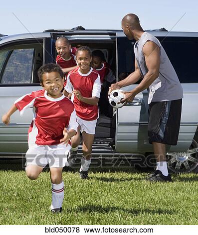 Stock Photo - Multi-ethnic children in soccer uniforms. Fotosearch