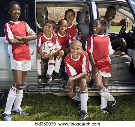 Stock Photo - Multi-ethnic children in soccer uniforms. Fotosearch