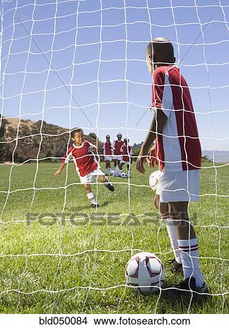 Picture - Multi-ethnic children playing soccer. Fotosearch