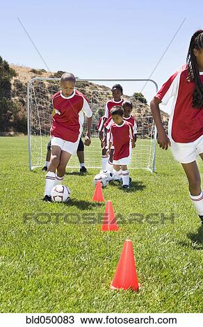 Multi-ethnic children playing soccer View Large Photo Image Stock Image - Multi-ethnic children playing soccer. Fotosearch