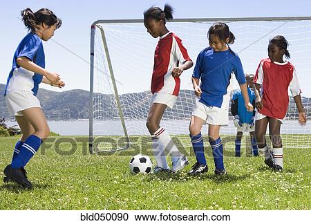 Multi-ethnic children playing soccer View Large Photo Image Stock Image - Multi-ethnic children playing soccer. Fotosearch