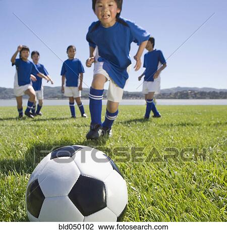 Multi-ethnic children playing soccer View Large Photo Image Stock Image - Multi-ethnic children playing soccer. Fotosearch