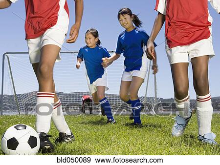 Multi-ethnic children playing soccer View Large Photo Image Stock Photo - Multi-ethnic children playing soccer. Fotosearch