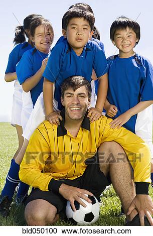 Multi-ethnic children with soccer coach View Large Photo Image Stock Image - Multi-ethnic children with soccer coach. Fotosearch