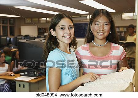 Multi-ethnic girls using library dictionary View Large Photo Image Picture - Multi-ethnic girls using library dictionary. Fotosearch