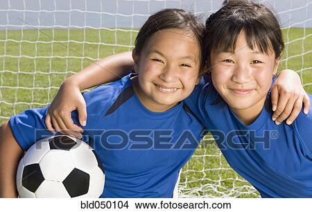 Picture - Multi-ethnic girls with soccer ball. Fotosearch