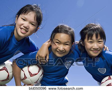 Multi-ethnic girls with soccer ball View Large Photo Image Stock Photograph - Multi-ethnic girls with soccer ball. Fotosearch