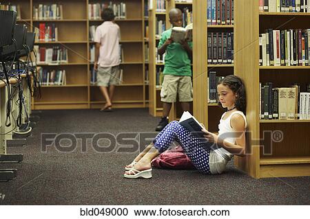 Multi-ethnic students reading library books View Large Photo Image Stock Image - Multi-ethnic students reading library books. Fotosearch