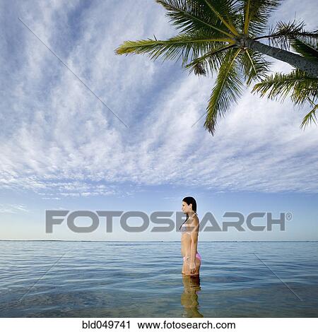 Pacific Islander woman standing in ocean View Large Photo Image Stock Image - Pacific Islander woman standing in ocean. Fotosearch