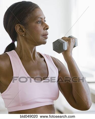 Senior African American woman lifting weights View Large Photo Image Stock Image - Senior African American woman lifting weights . Fotosearch