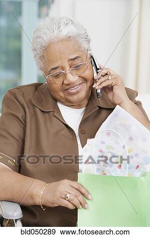 Senior African American woman talking on cell phone View Large Photo Image Stock Photo - Senior African American woman talking on cell phone. Fotosearch