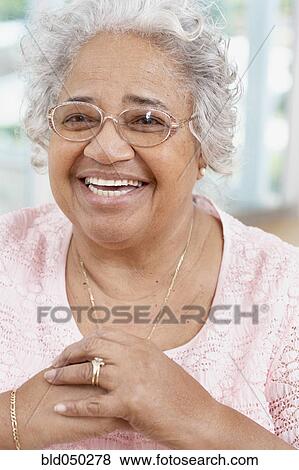 Senior African American woman wearing eyeglasses View Large Photo Image Stock Photo - Senior African American woman wearing eyeglasses. Fotosearch
