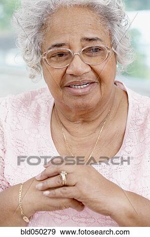 Senior African American woman wearing eyeglasses View Large Photo Image Stock Photo - Senior African American woman wearing eyeglasses. Fotosearch