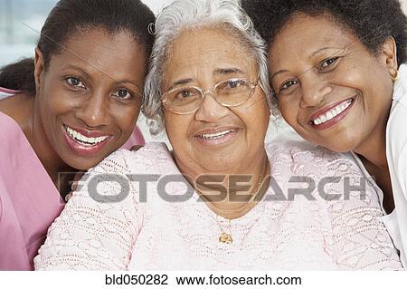 Senior African American woman with nurse and daughter View Large Photo Image Stock Image - Senior African American woman with nurse and daughter. Fotosearch