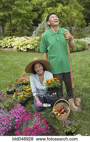 Stock Photo - Senior Asian couple gardening. Fotosearch