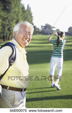 Senior Asian man on golf course View Large Photo Image Stock Photography - Senior Asian man on golf course. Fotosearch