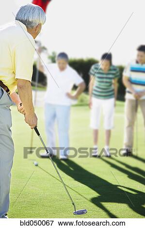 Senior Asian man playing golf View Large Photo Image Stock Photo - Senior Asian man playing golf. Fotosearch