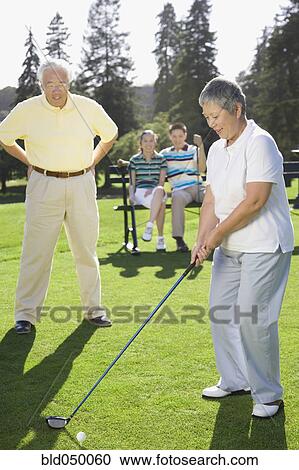 Senior Asian woman playing golf View Large Photo Image Stock Image - Senior Asian woman playing golf. Fotosearch