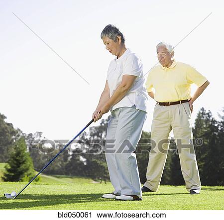 Senior Asian woman playing golf View Large Photo Image Stock Image - Senior Asian woman playing golf. Fotosearch