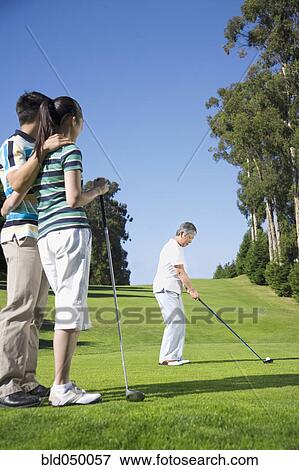 Stock Photo - Senior Asian woman playing golf. Fotosearch