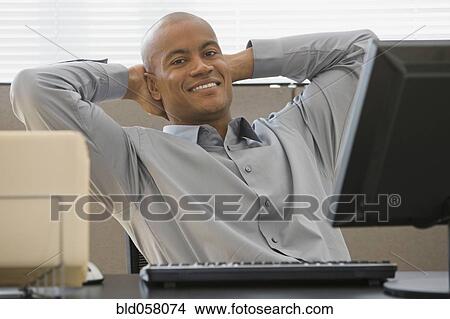African businessman with hands behind head View Large Photo Image Picture - African businessman with hands behind head. Fotosearch