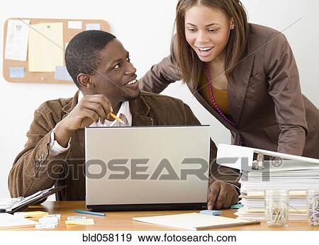 African businesspeople looking at laptop View Large Photo Image Stock Photo - African businesspeople looking at laptop. Fotosearch