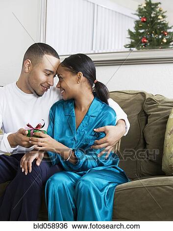 Stock Photograph - African couple holding gift. Fotosearch