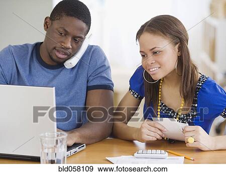 African couple paying bills View Large Photo Image Stock Photo - African couple paying bills. Fotosearch