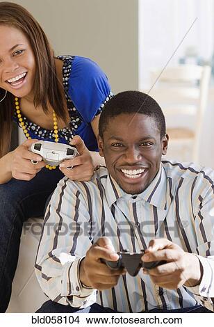 Picture - African couple playing video games. Fotosearch