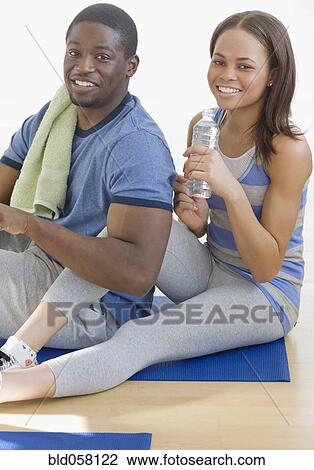 African couple sitting on yoga mat View Large Photo Image Stock Image - African couple sitting on yoga mat. Fotosearch