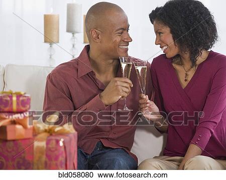 African couple toasting with champagne View Large Photo Image Stock Image - African couple toasting with champagne. Fotosearch