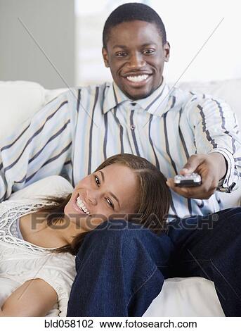 African couple watching television View Large Photo Image Stock Image - African couple watching television. Fotosearch