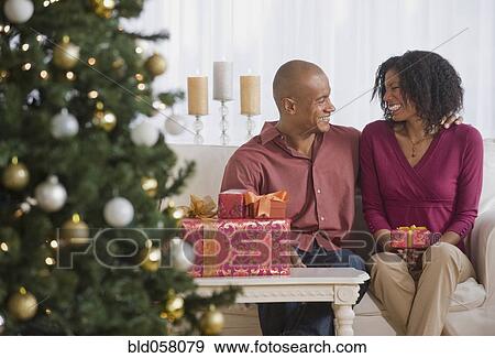 Stock Photo - African couple with Christmas gifts. Fotosearch