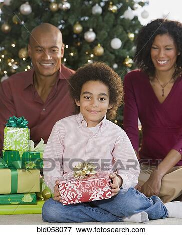 Stock Photo - African family with Christmas gifts. Fotosearch