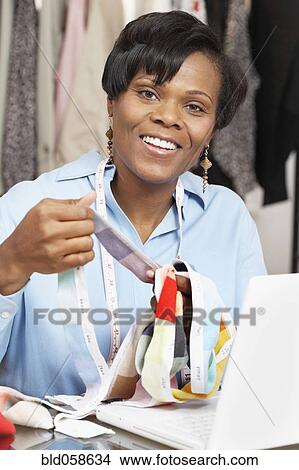African fashion designer holding fabric swatches View Large Photo Image Picture - African fashion designer holding fabric swatches. Fotosearch