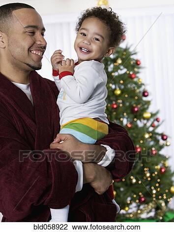 Stock Image - African father and baby laughing. Fotosearch