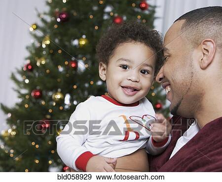 Stock Photo - African father smiling at baby. Fotosearch