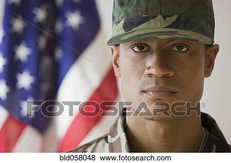 Stock Photo - African male soldier in front of American flag. Fotosearch