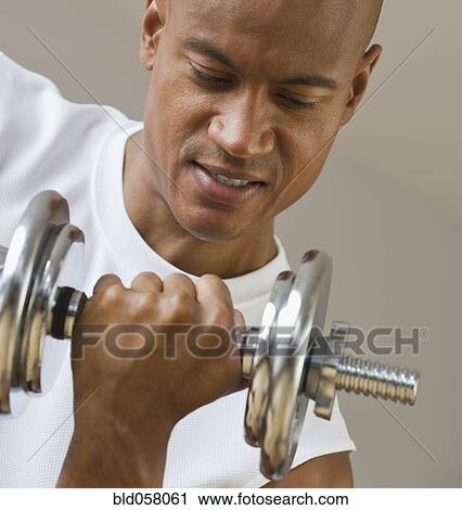 African man lifting dumbbell View Large Photo Image Stock Image - African man lifting dumbbell. Fotosearch