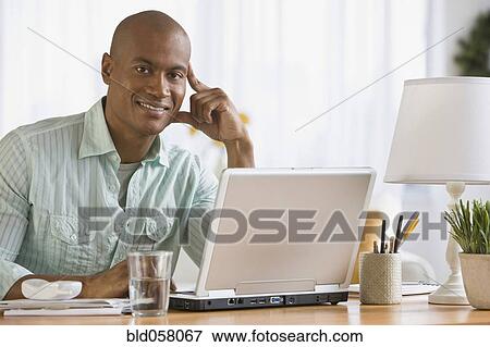 African man next to laptop View Large Photo Image Stock Photo - African man next to laptop. Fotosearch