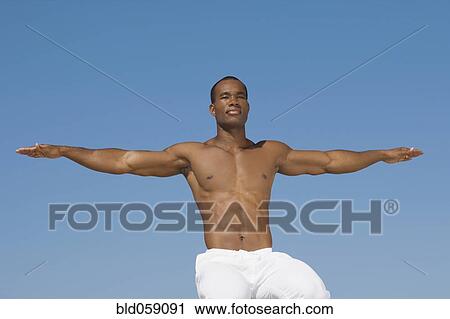 Stock Image - African man practicing yoga. Fotosearch