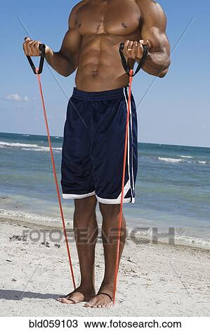 African man stretching with exercise band View Large Photo Image Stock Image - African man stretching with exercise band. Fotosearch