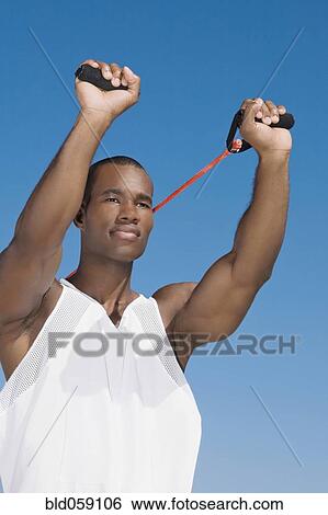 African man stretching with exercise band View Large Photo Image Stock Photograph - African man stretching with exercise band. Fotosearch