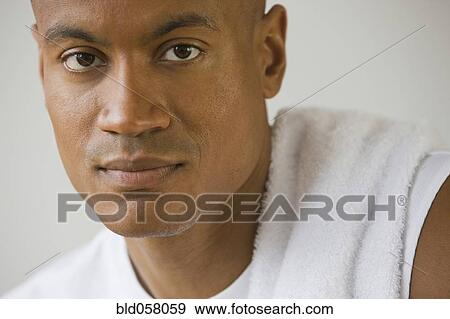 Stock Photo - African man with towel on shoulder. Fotosearch