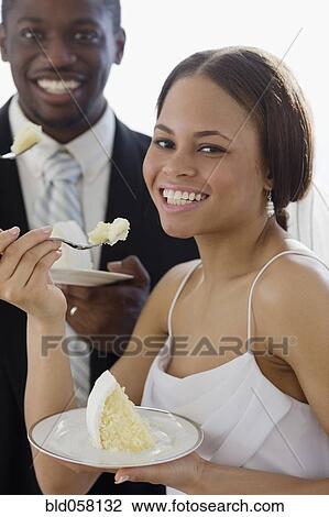 African newlyweds eating cake View Large Photo Image Stock Image - African newlyweds eating cake. Fotosearch